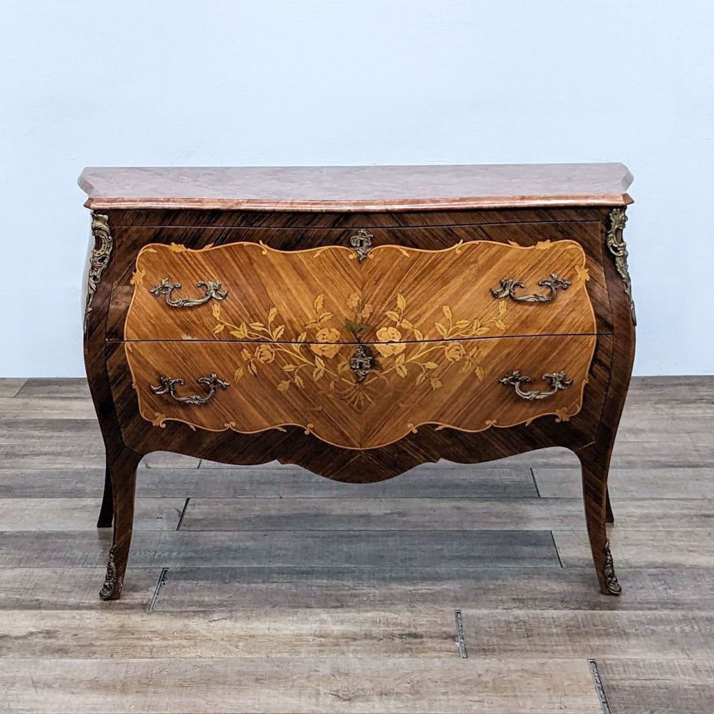 Antique French Louis XV dresser with wood inlay, pink marble top, and brass hardware by Reperch.