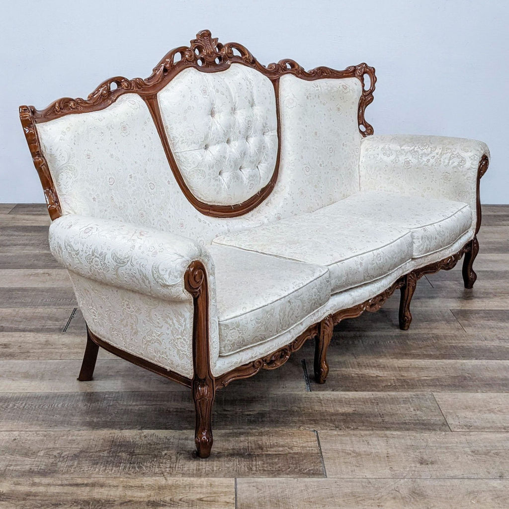 Elegant Reperch brand sofa featuring intricate wood detailing and ornate upholstery.