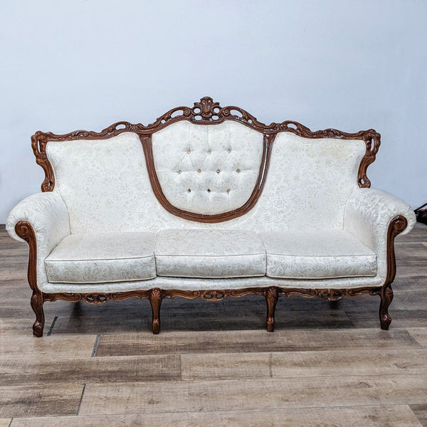Victorian-inspired 3-seat sofa with damask fabric and carved wood accents.