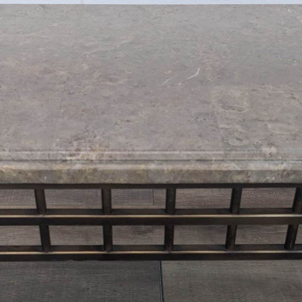 Close-up of Reperch table's marble surface and metal grid design.
