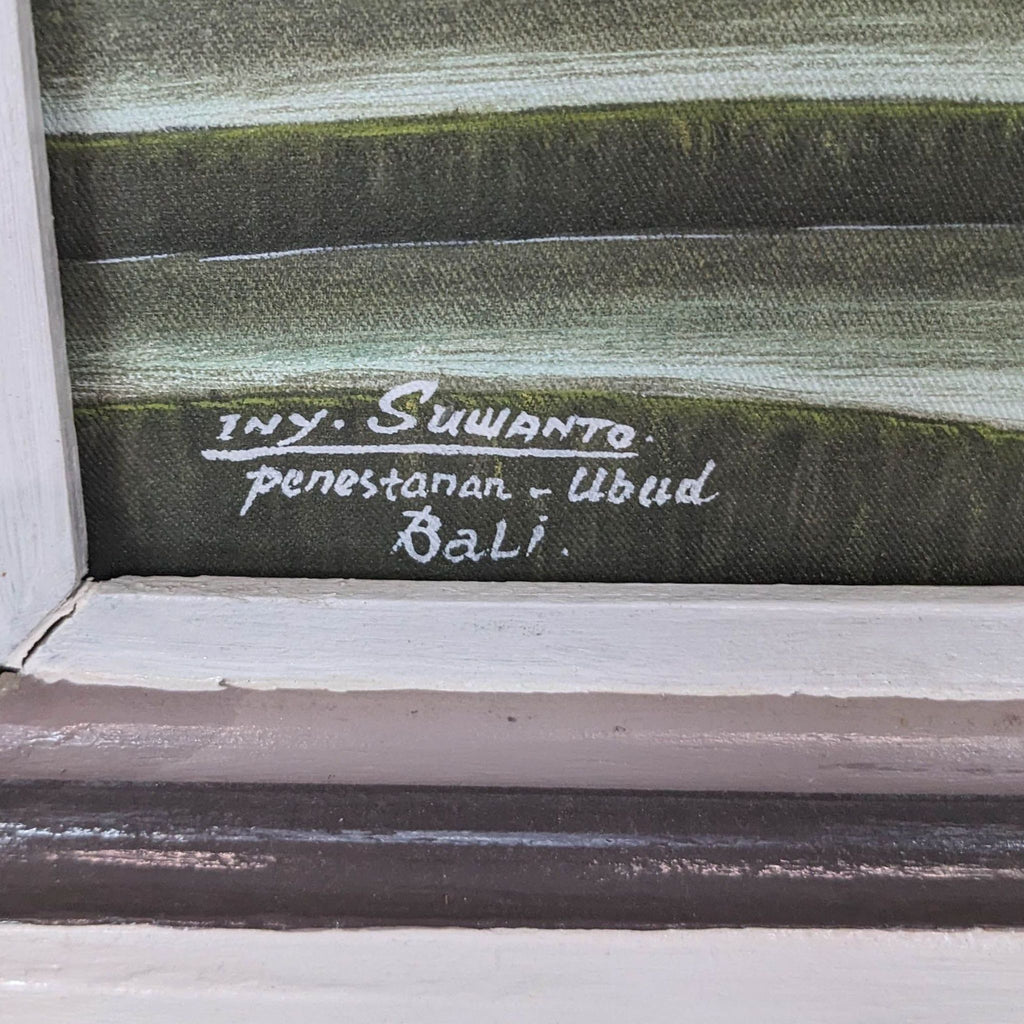 Artist's signature on painting from Bali, showcasing location and name.