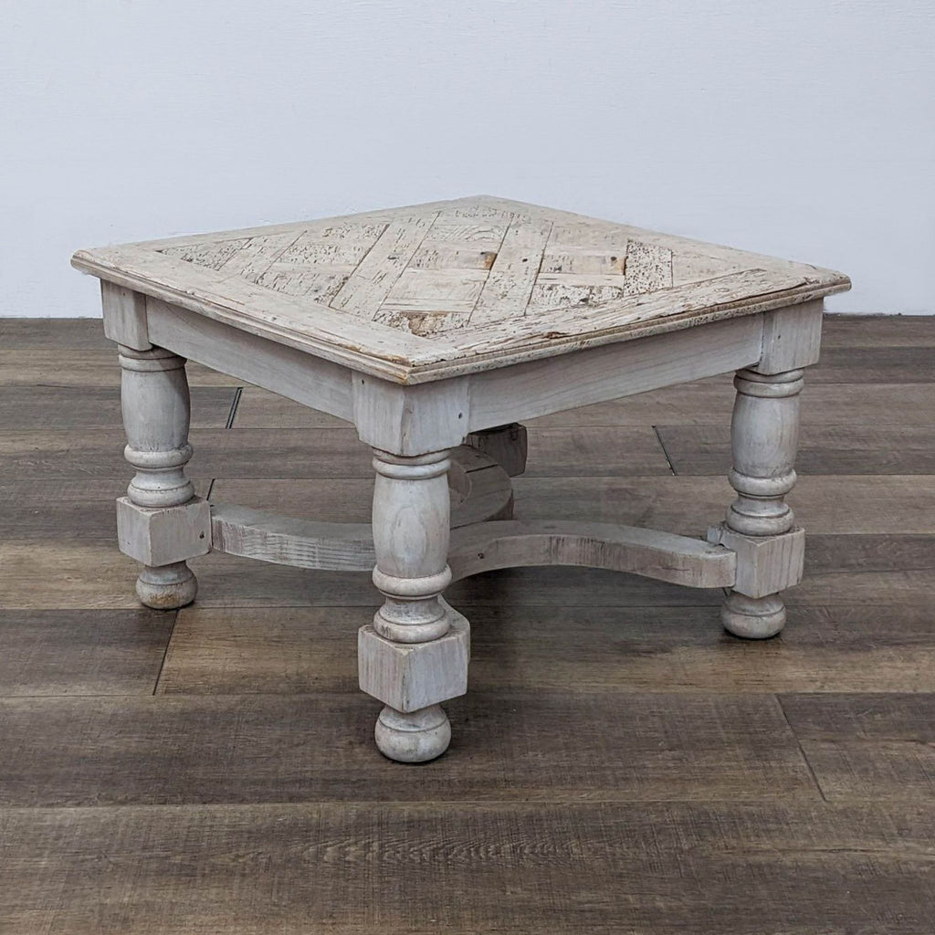 Reclaimed wood table with ornate turned legs, showcasing a rustic square surface.