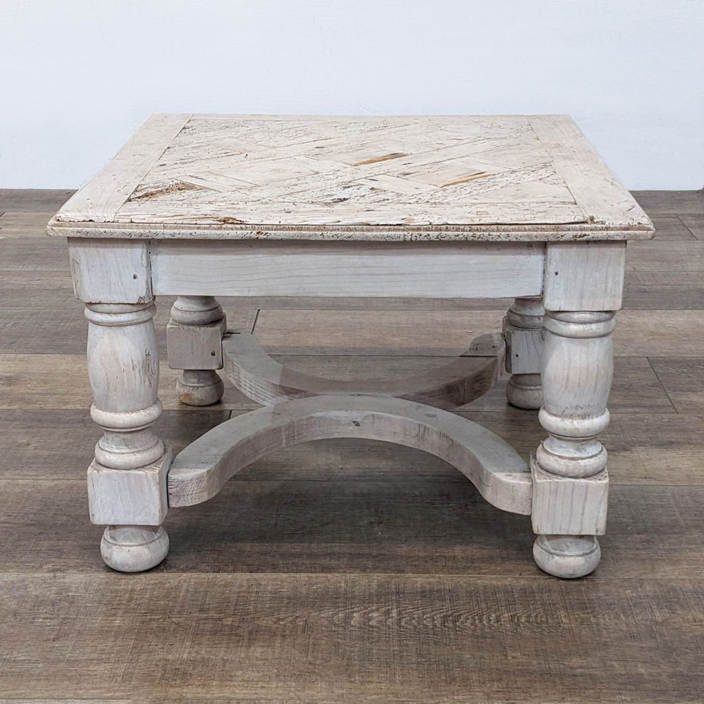 Antique-style reclaimed wood table with turned legs and a square top.