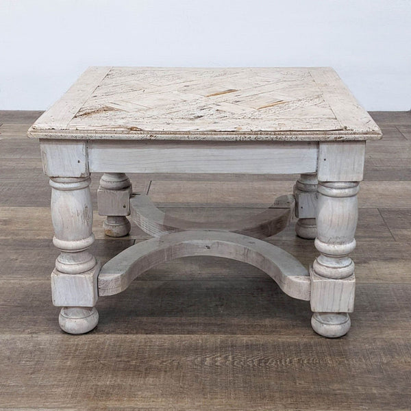 Antique-style reclaimed wood table with turned legs and a square top.