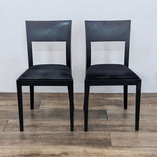 Pair of Reperch dining chairs with solid wood frames, curved backs, and upholstered black seats.