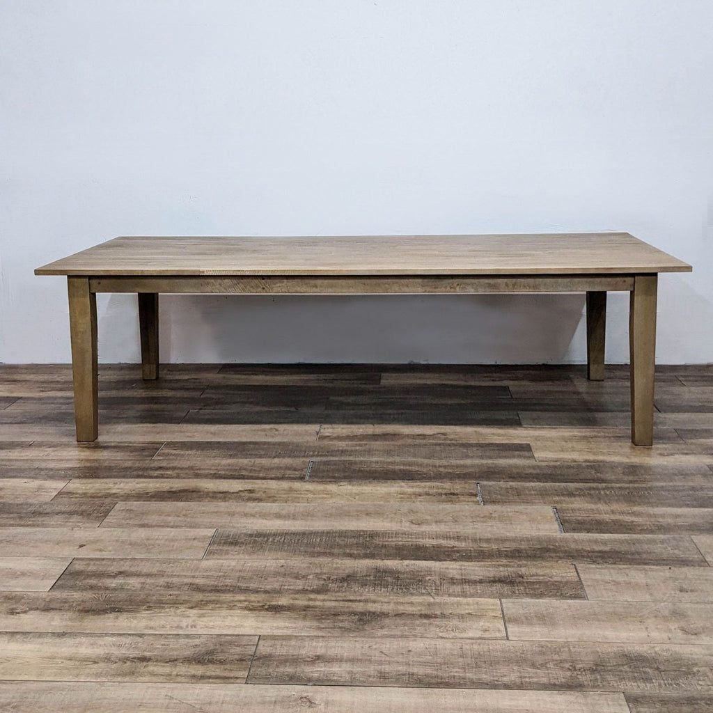 Wooden table from the Reperch dining set, showcasing a natural wood finish.