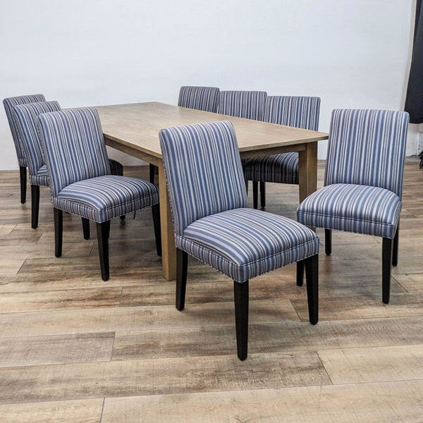Dining set with a wooden table and 8 striped chairs, part of the Reperch brand collection.