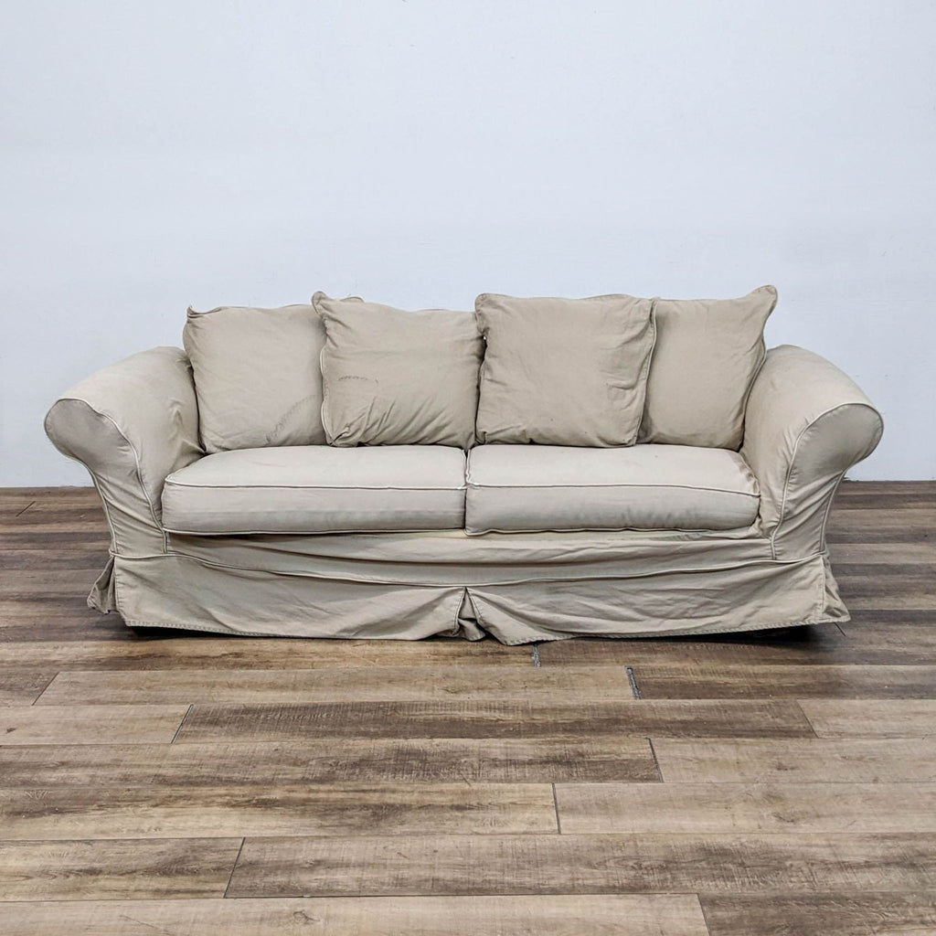 Pottery Barn Charleston Sleeper Sofa with slipcover in a living room.