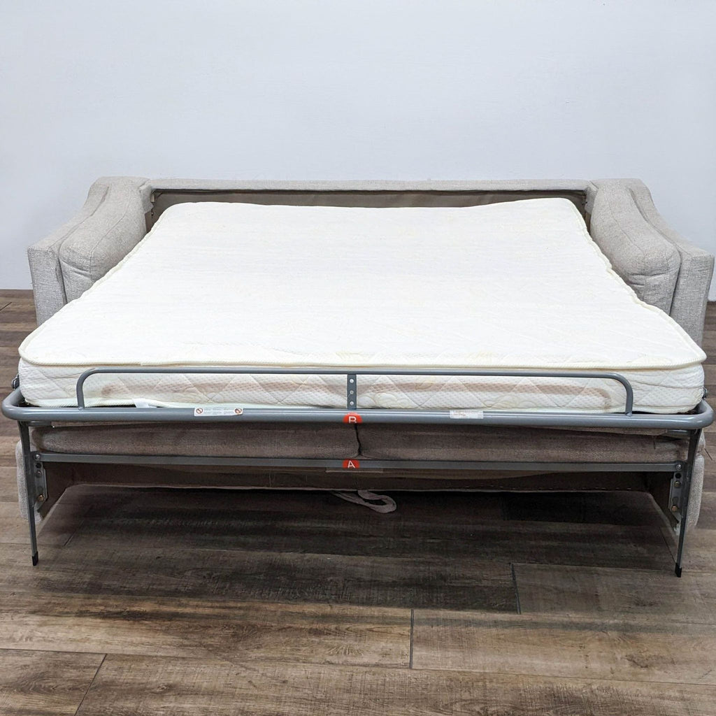 Sleeper sofa opened into queen bed, featuring mattress.