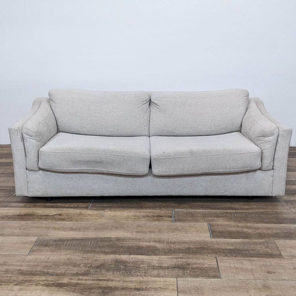 Contemporary grey sleeper sofa from Living Spaces, front view.
