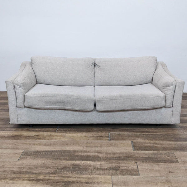 Contemporary grey sleeper sofa from Living Spaces, front view.