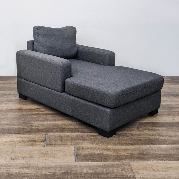 Gray chaise lounge with square arms and plush cushions from Reperch.  