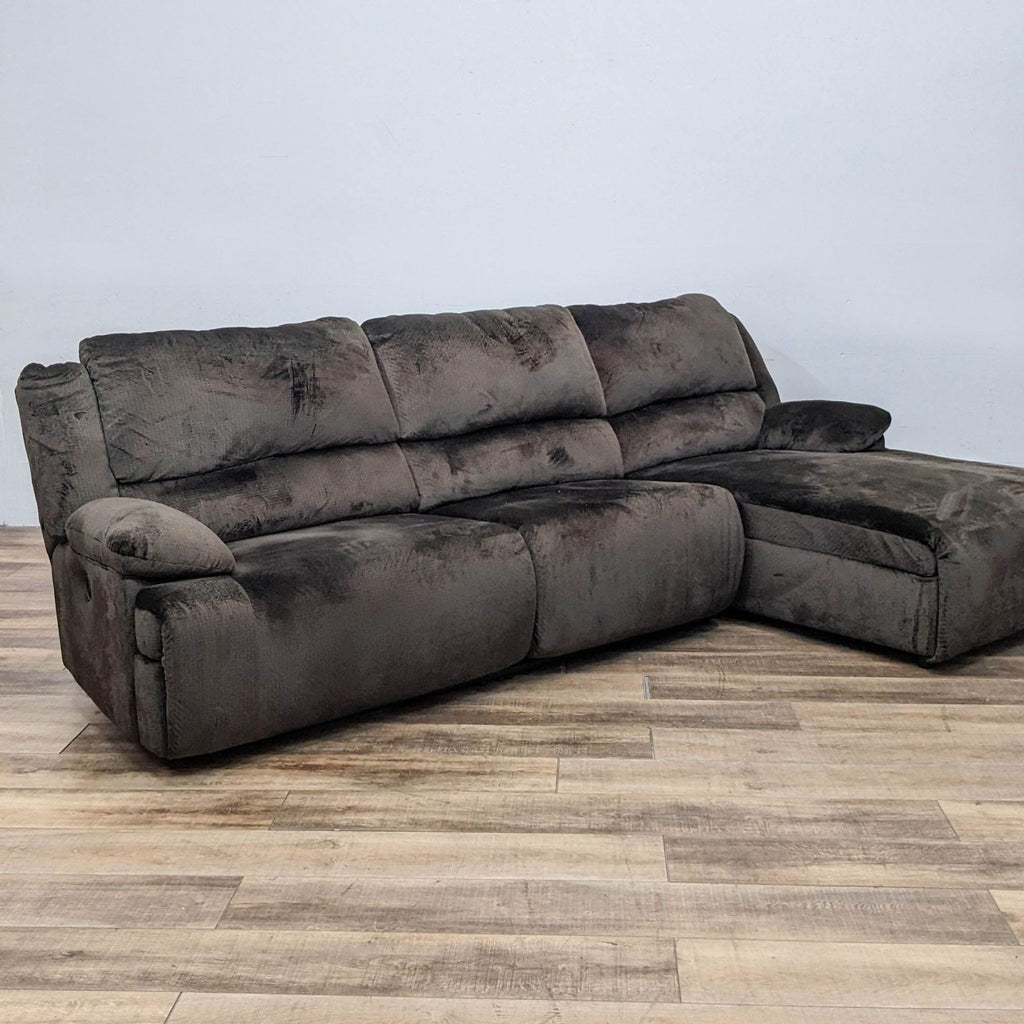 Brown fabric sectional with power reclining end and chaise. Pillow top arms. Front view.