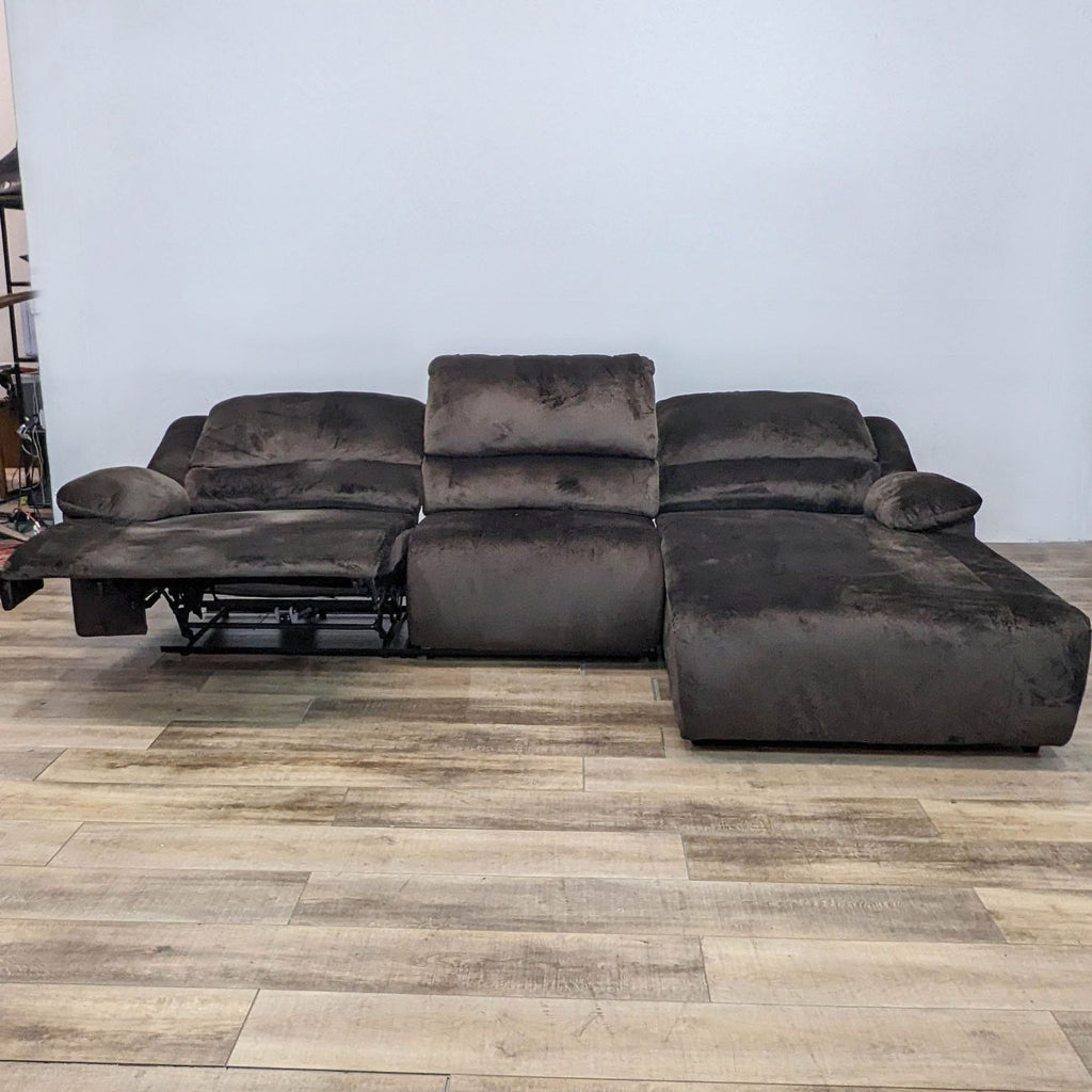 Reperch sectional with one reclining seat and chaise. Cozy fabric and pillow arms. Facing front.