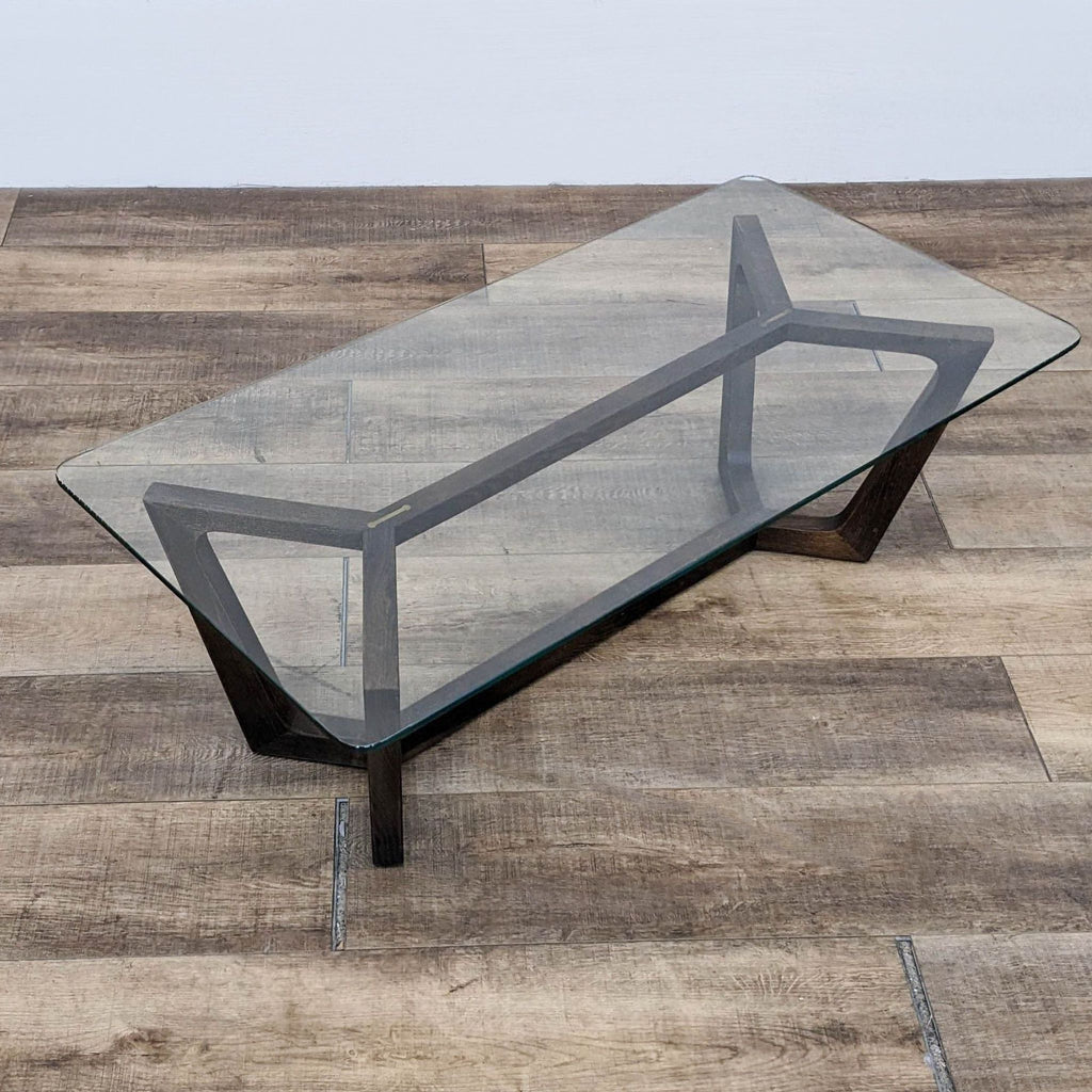 Rectangular coffee table with glass surface and wood trestle base by Square Roots Furniture.