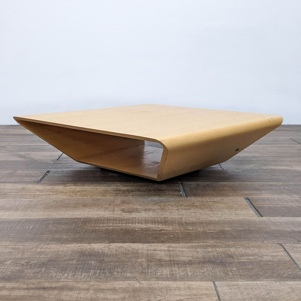 Side view of the Swedese Brasilia table's sculptural, looped design.