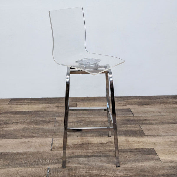 High back acrylic stool with metal base on wooden floor, side view.