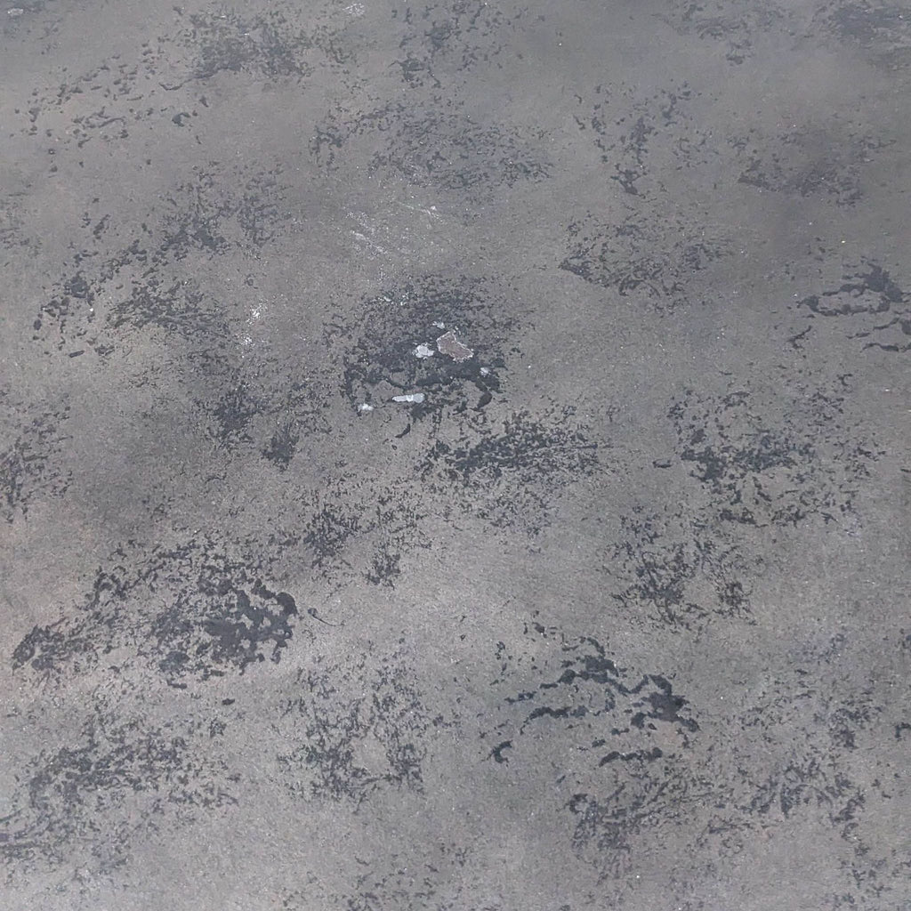 Close-up of distressed black metal tabletop texture.