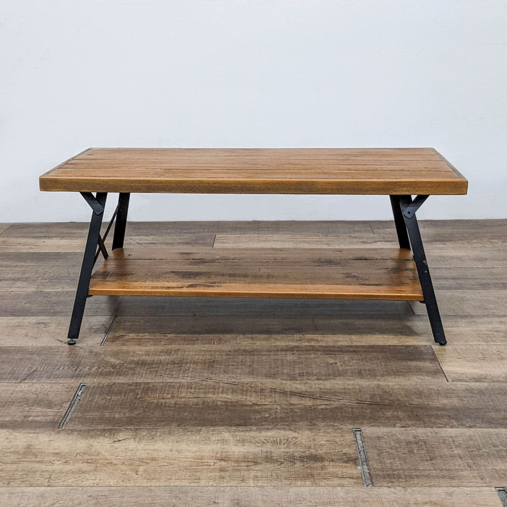 Reperch coffee table with x-leg steel frame and planked pine top.