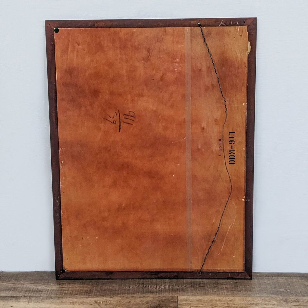 Back of wooden-framed mirror showing mounting wire and panel details.