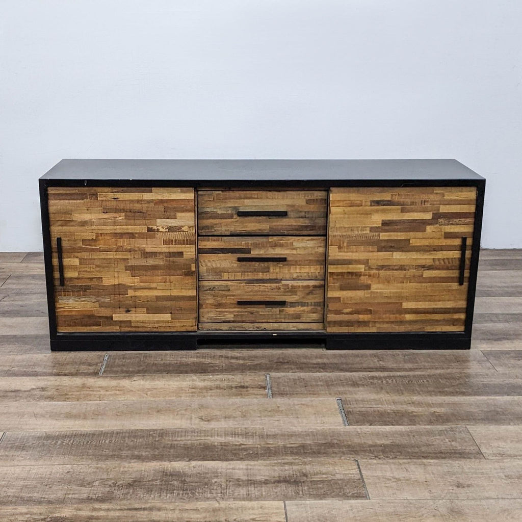 Front view of Crate & Barrel entertainment center with wood sliding doors and drawers.