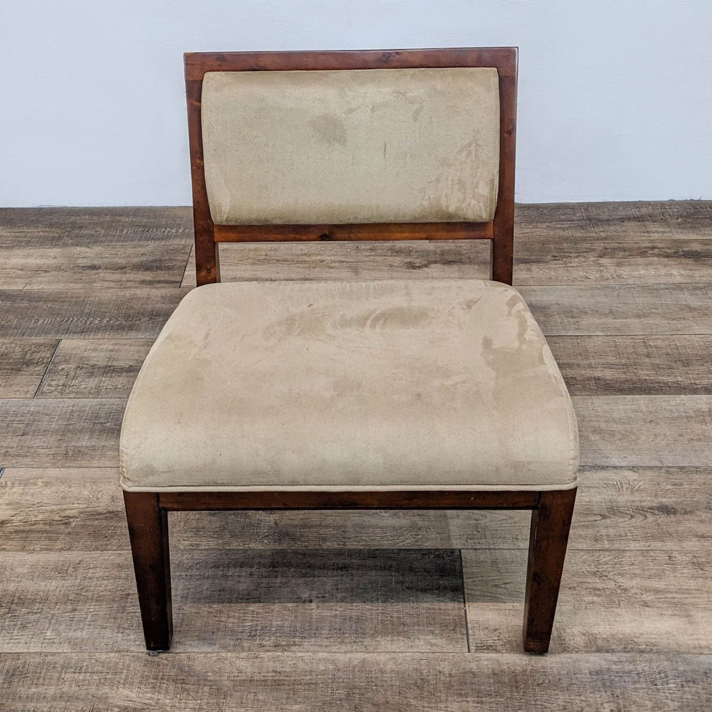 Wooden-framed slipper chair with beige microfiber upholstery on a wooden floor.