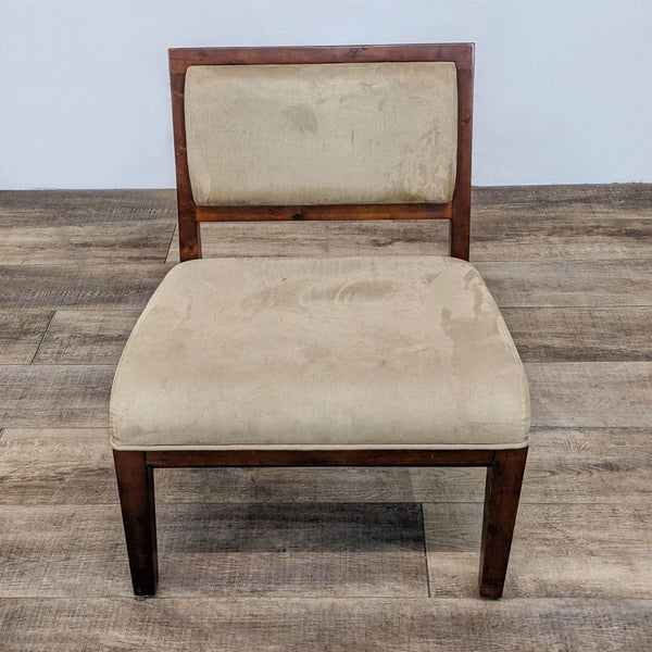 Wooden-framed slipper chair with beige microfiber upholstery on a wooden floor.