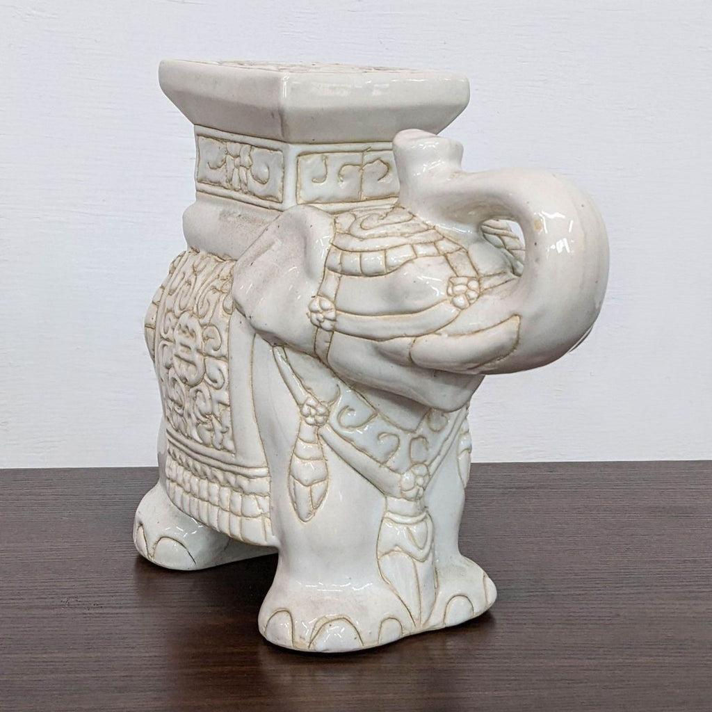 Side view of a porcelain elephant garden sculpture by Reperch.