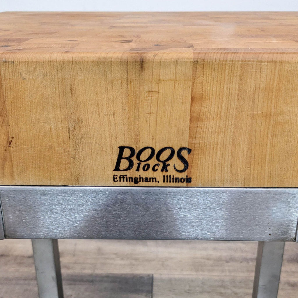 Boos Block logo on maple butcher block with metal base.