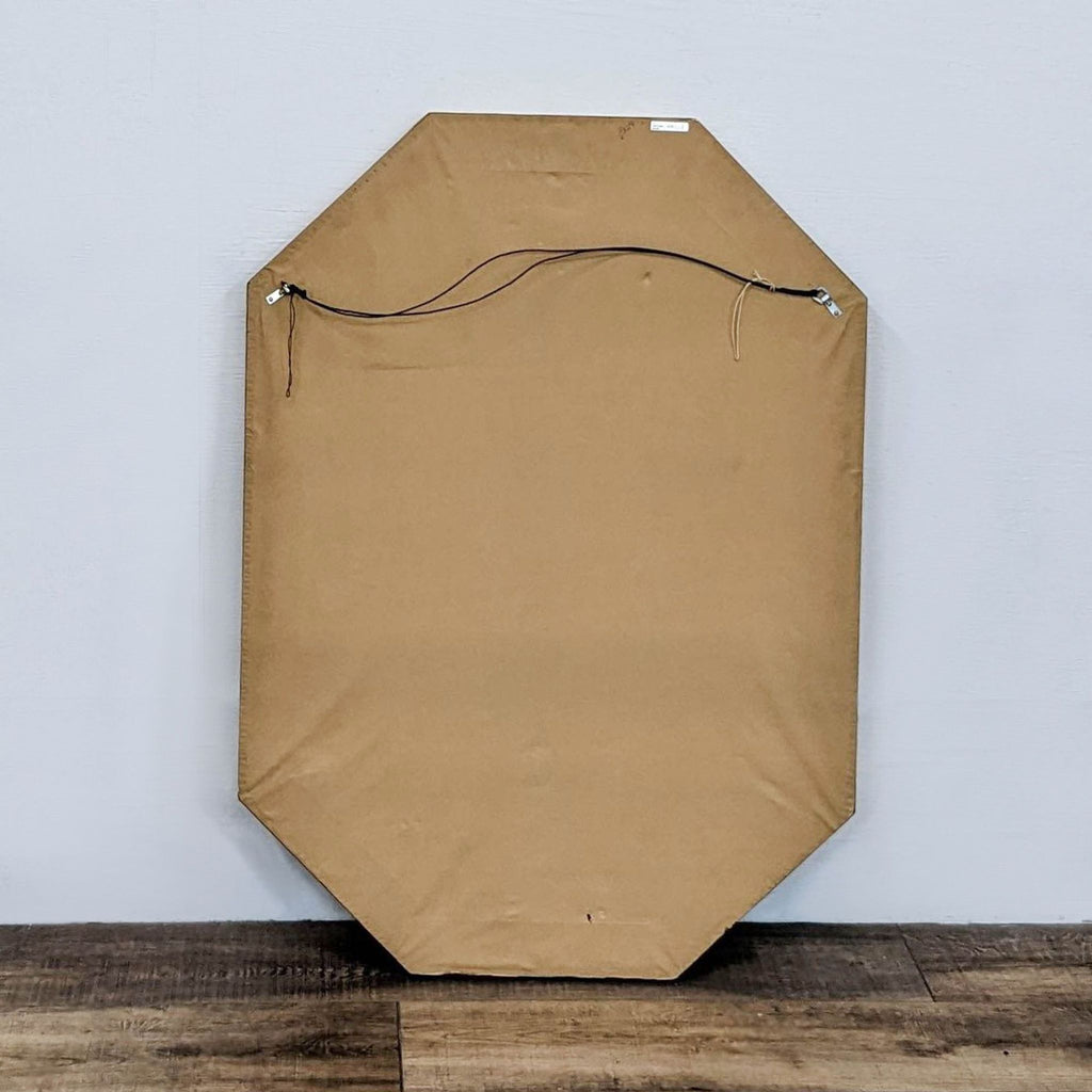 Back view of the octagonal vintage mirror, showing its secure hanging wire setup.