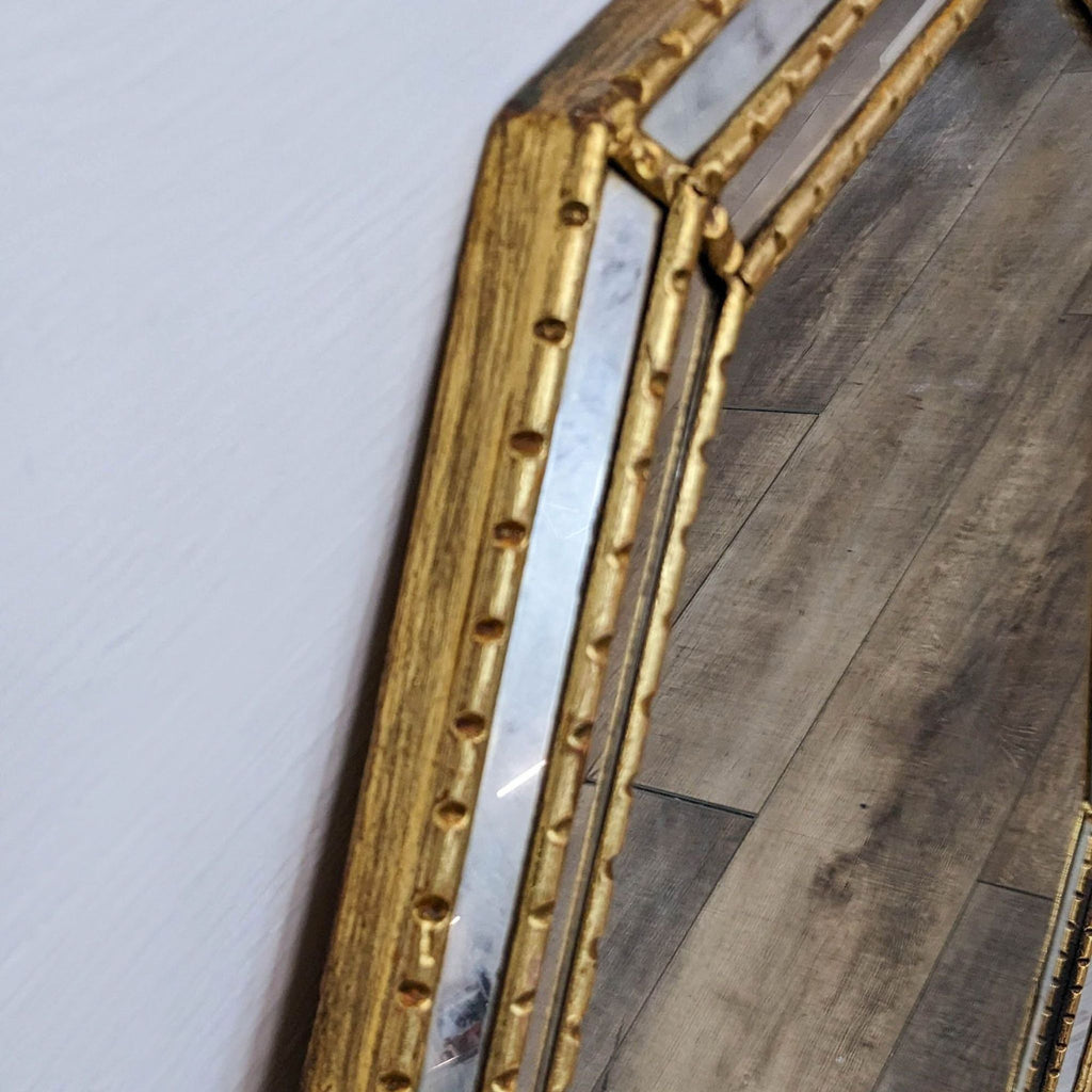 Close-up of the gilt faux bamboo frame showcasing detailed carving and beveled edges.