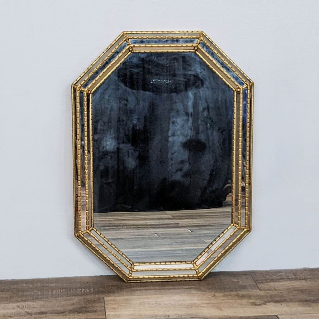 Vintage 1970s octagonal mirror with faux bamboo carved wood frame in gilt finish.