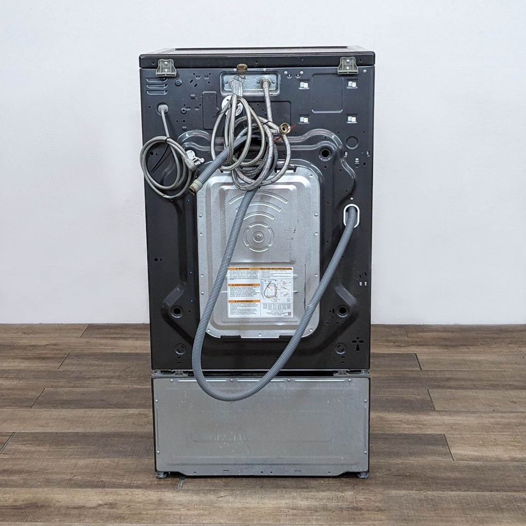 Back view of LG washer/dryer highlighting cords and metal paneling.