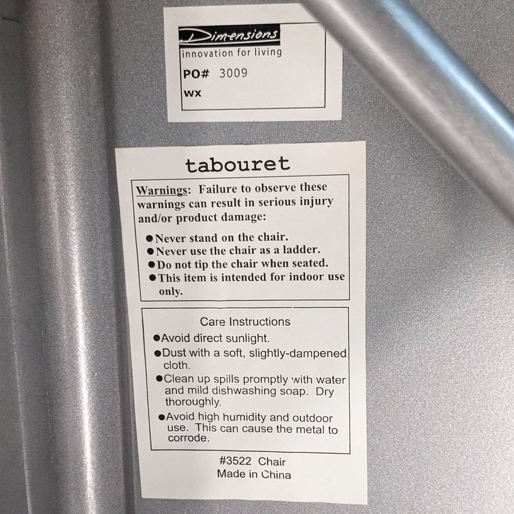 Close-up of care instructions and warnings label on Dimensions Tabouret chair.