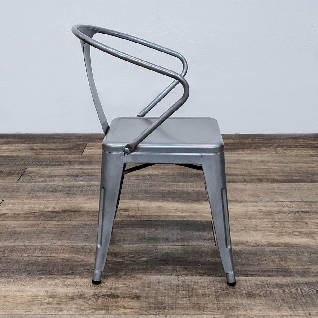Side view of Dimensions Tabouret chair showcasing metal construction and modern style.