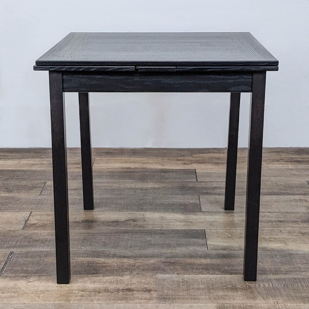 Square dining table with straight legs from Hammel Furniture, designed with pull-out leaves for extension.
