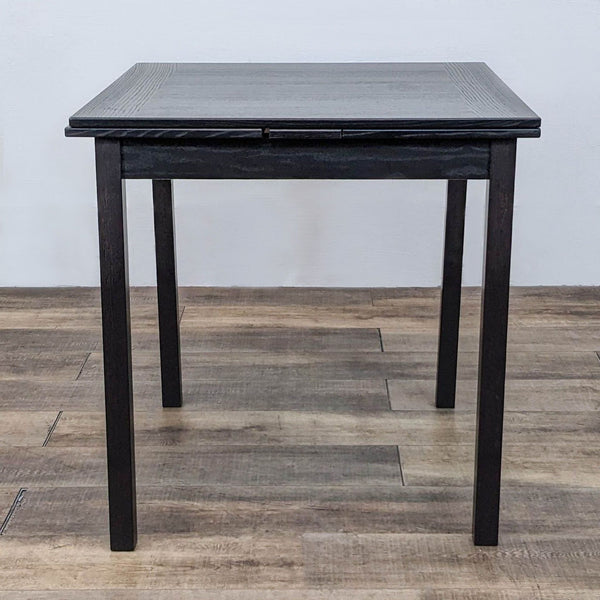 Square dining table with straight legs from Hammel Furniture, designed with pull-out leaves for extension.