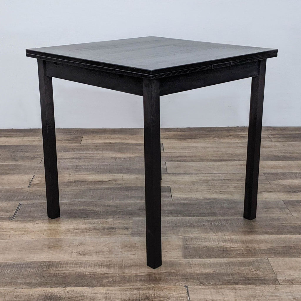 Dines extension table by Hammel, featuring a square top, straight legs, and extendable pull-out leaves.