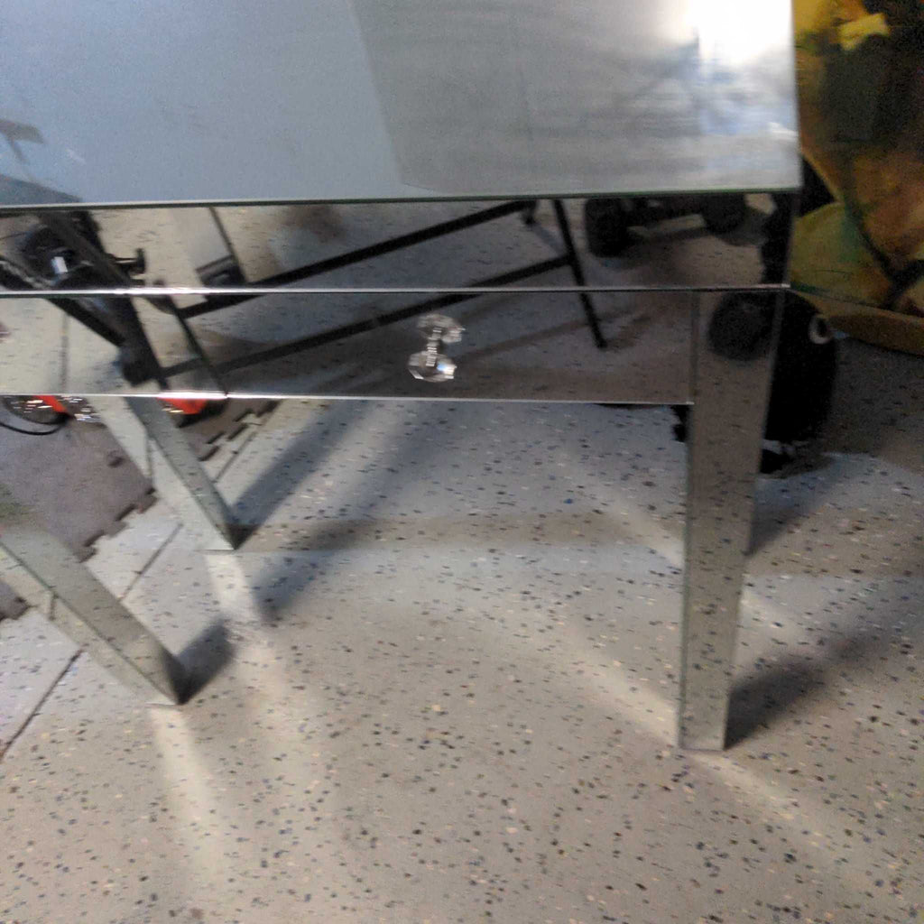Mirrored side or console table with a reflective finish and a single drawer, featuring a glass knob handle.