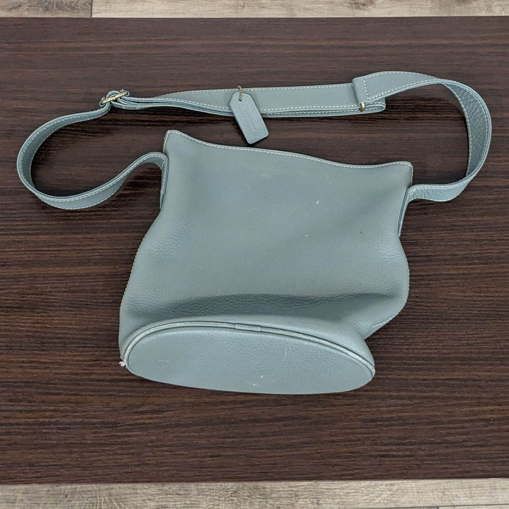Top view of a Coach purse showing its adjustable strap.