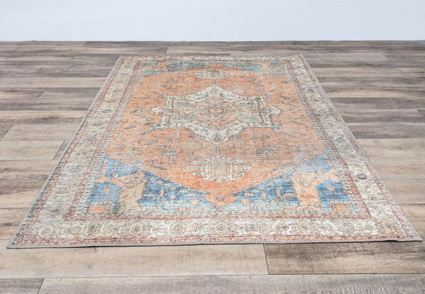 Reperch Persian area rug, 6'x9', with intricate geometric patterns in orange and blue tones.