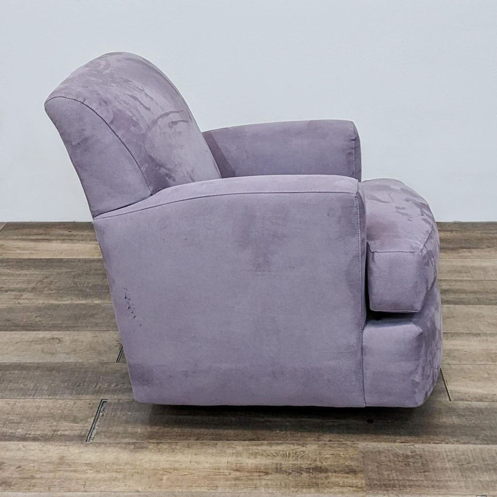 Side view of a Carter chair in microfiber, featuring cushioned arms and metal glider base.