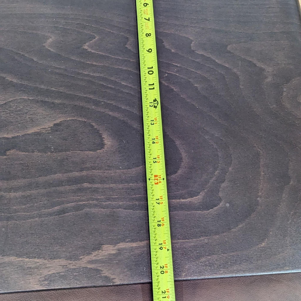 3. Close-up of a measuring tape on dark wood with visible grain pattern.