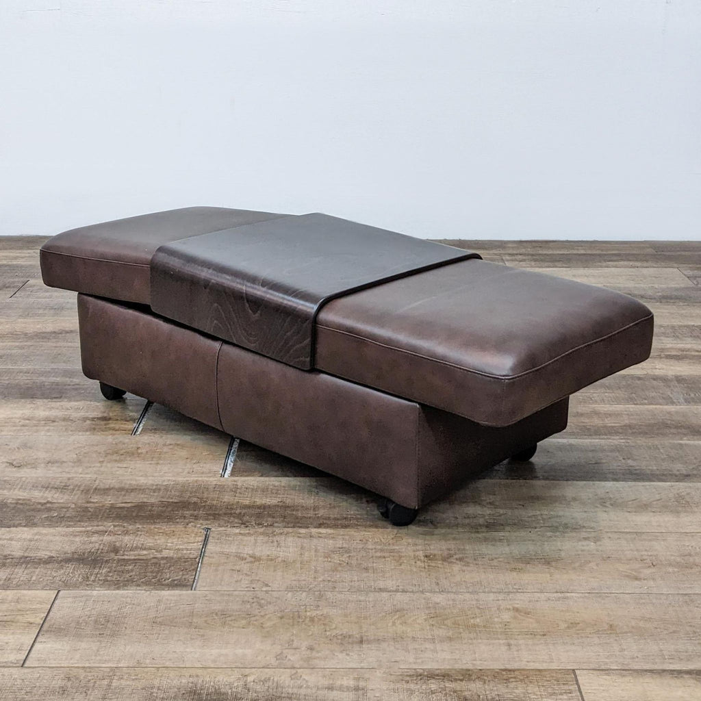 1. Brown leather ottoman bench with storage and casters on a wooden floor.
