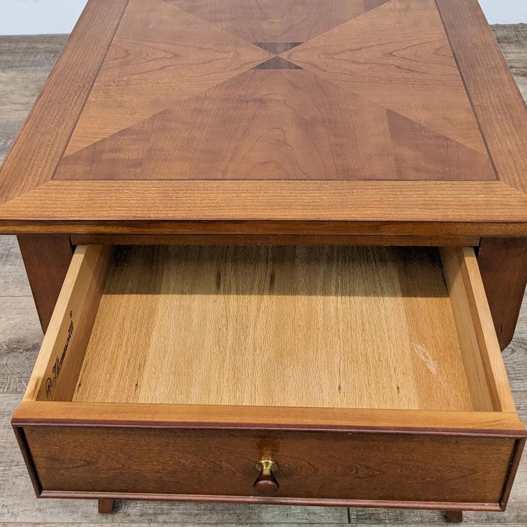 Close-up of Thomasville end table, showing open drawer with detailed wood grain pattern.