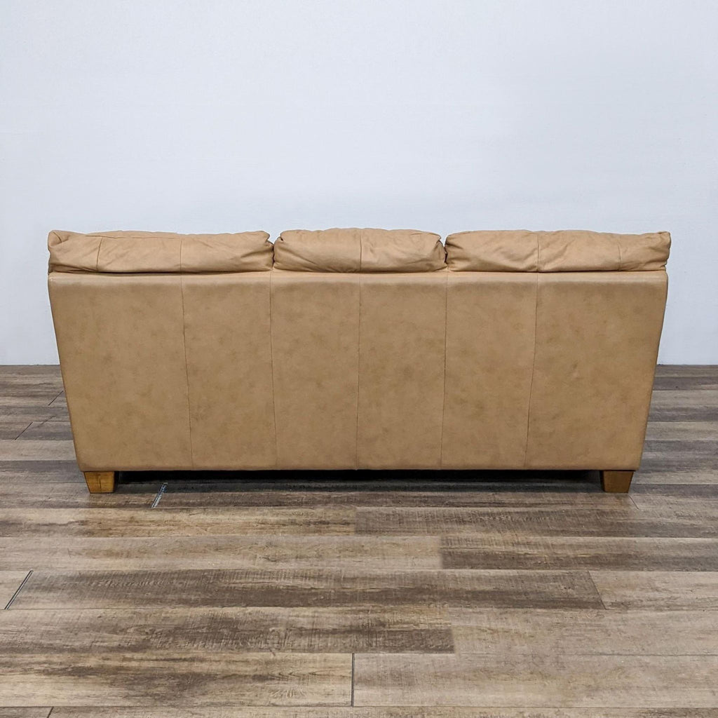 Back view of a Reperch tan leather sofa with three sections.