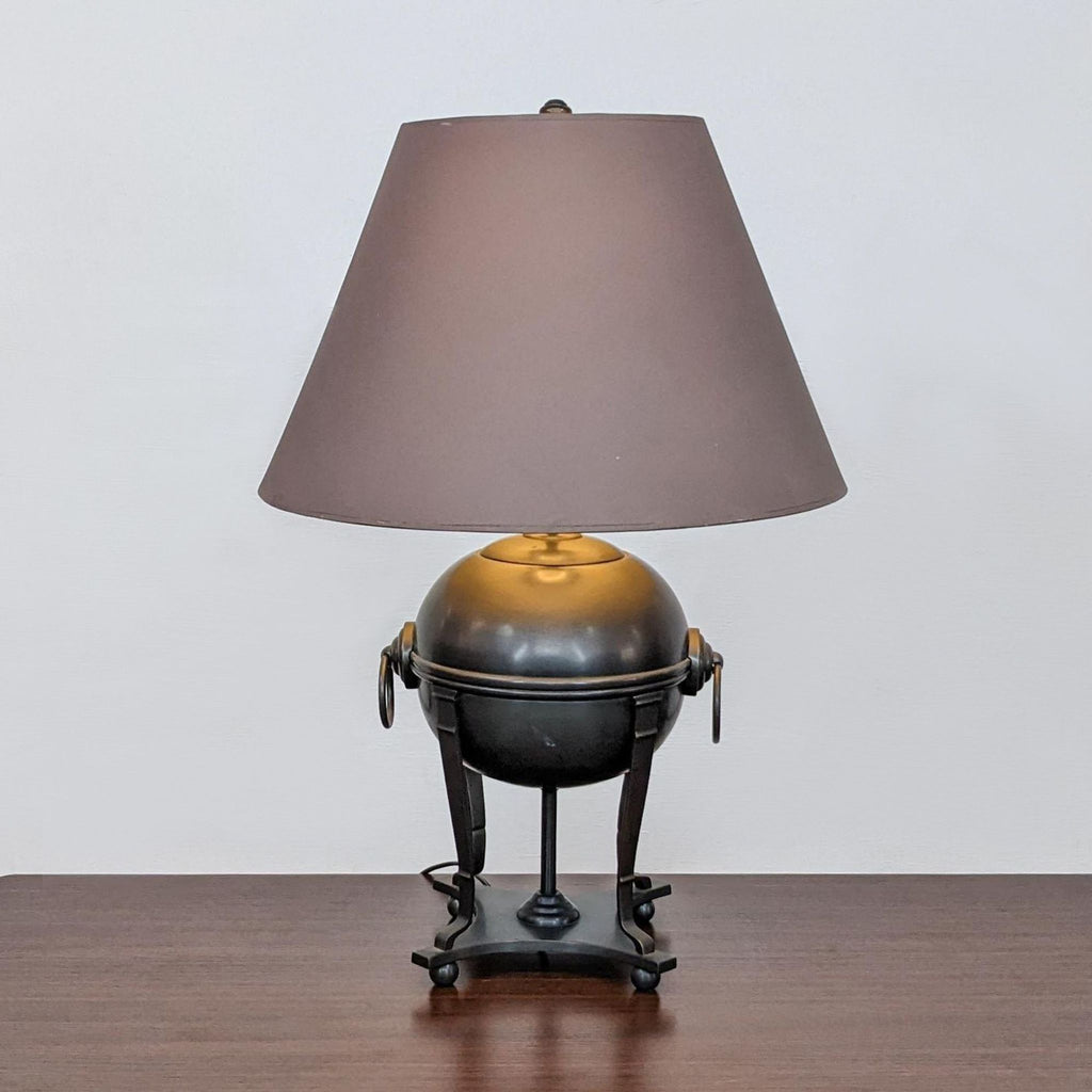Reperch table lamp with a brown shade on a wooden surface.