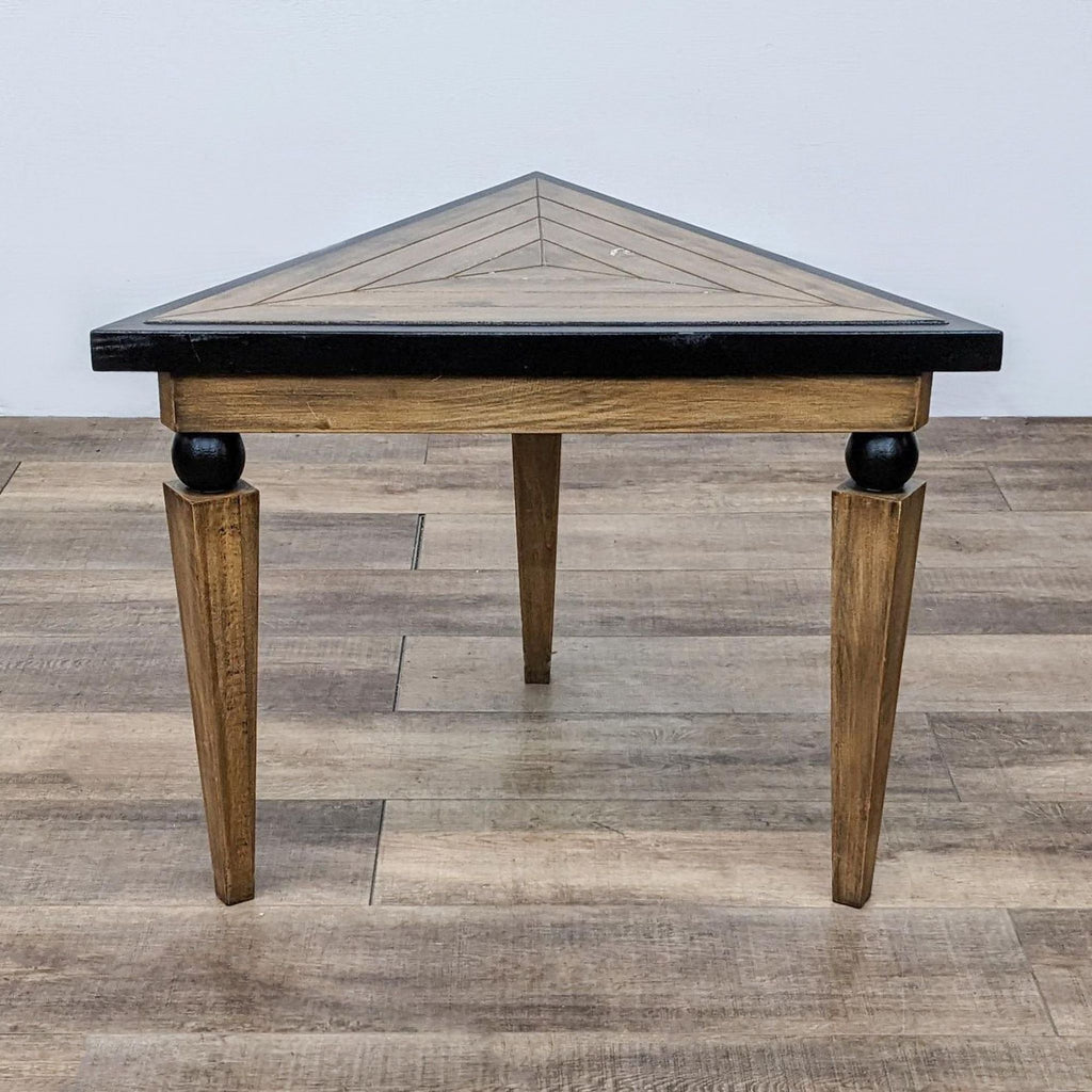 Triangular wooden console table with tapered legs and black trim by Reperch.