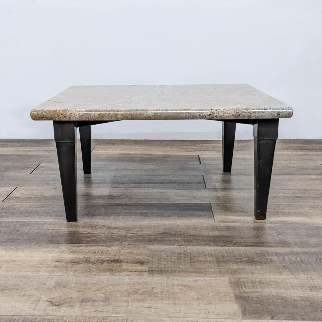 1. Modern coffee table featuring a sleek metal base design.  