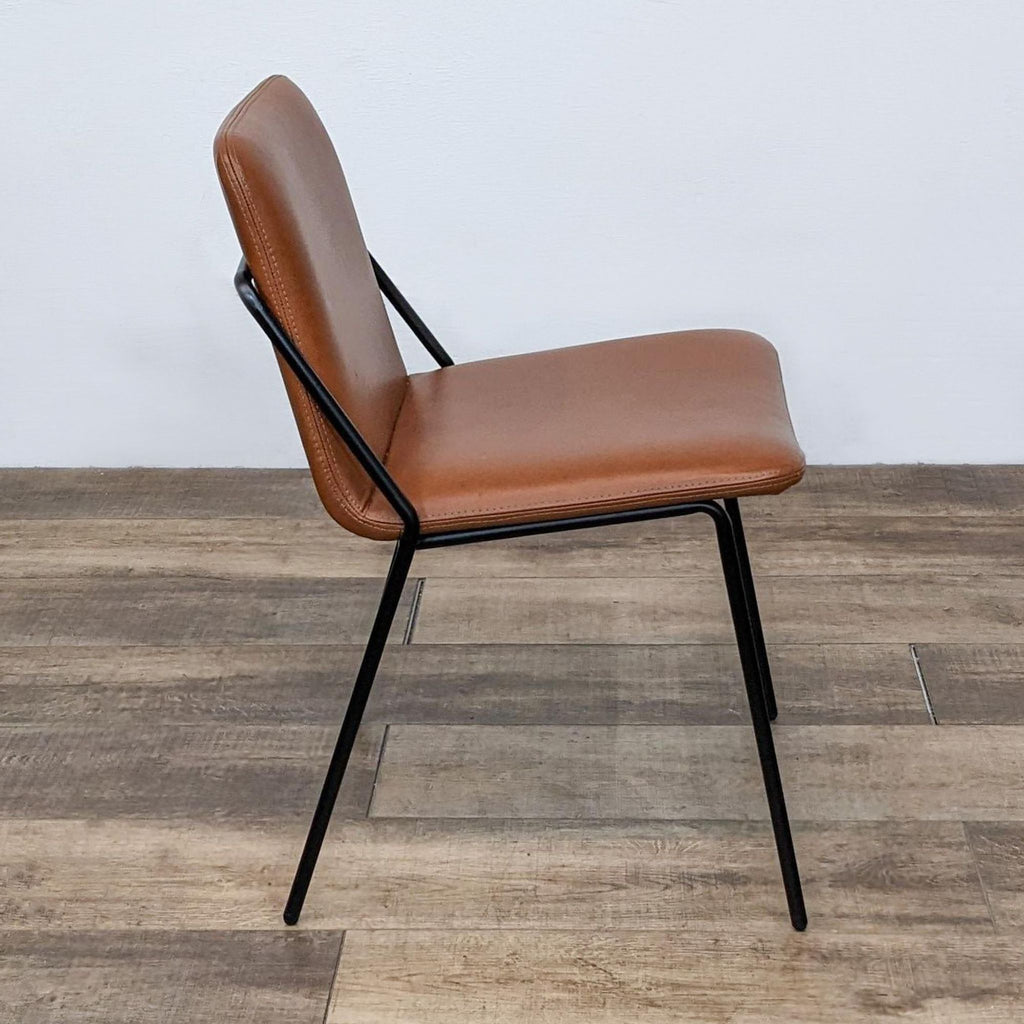 Side view of modern dining chair, black legs, vegan leather.